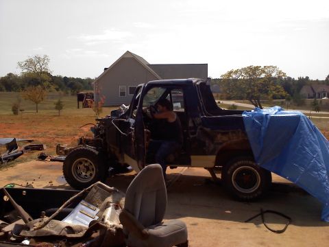 1995 Ford Bronco - This vehicle appears to be undergoing significant repairs or dismantling, with many parts removed and exposed.