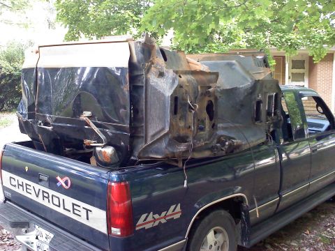 1995 Ford Bronco - Damaged vehicle body being transported in a Chevrolet pickup truck.