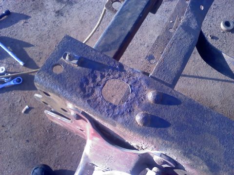 1995 Ford Bronco - Close-up of a heavily rusted metal frame component, likely from a vehicle's chassis.
