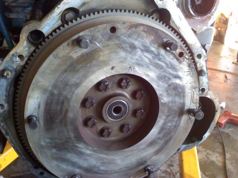 1995 Ford Bronco - This image shows a close-up view of an engine's flywheel and its associated starter ring gear.