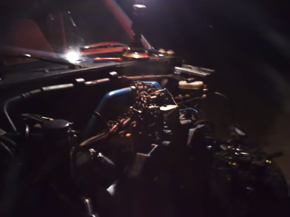 Engine bay with blue intake pipe and chain