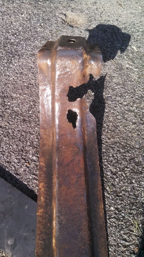 1979 Ford Bronco - A heavily rusted metal component with significant damage and holes is shown lying on the ground, with a Supermotors.net watermark.