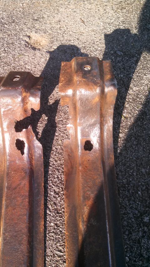 1979 Ford Bronco - These heavily rusted metal brackets appear to be structural components, possibly from a vehicle.