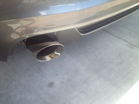 2013 Ford Mustang - Close-up of the chrome exhaust pipe and rear bumper detail on a 2013 Ford Mustang.