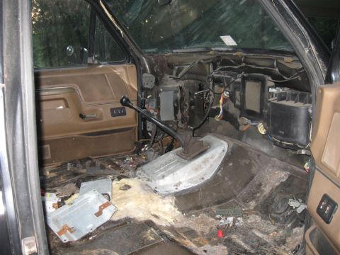 1990 Ford Bronco - The interior of this vehicle is in disarray, with parts removed and debris scattered across the floor.