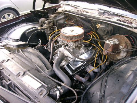1975 Chevrolet Chevelle - The engine bay of a 1975 Chevrolet Chevelle is visible, with the V8 engine and associated components clearly displayed.