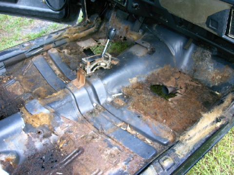 1975 Chevrolet Chevelle - The floor of this car interior is heavily rusted and damaged, with the original carpet missing.