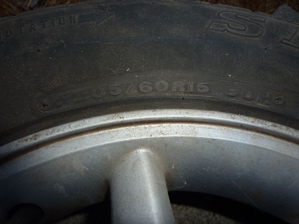Tire size 205/60R15 90H on a silver alloy wheel