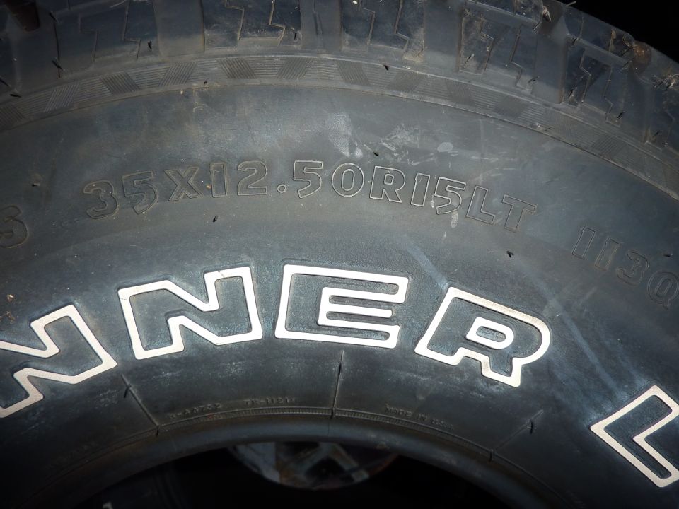 Close-up of a tire with size 35X12.50R15LT and brand name HAMMER.