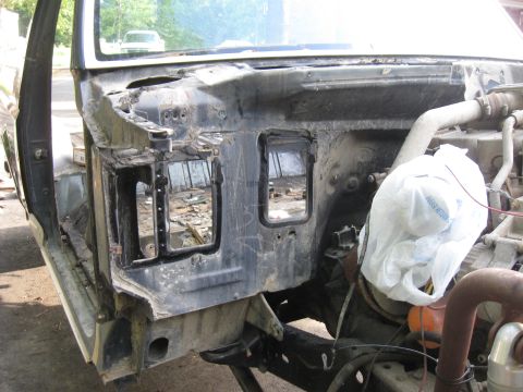 1990 Ford Bronco - The image shows the firewall and engine bay of a vehicle under restoration. The interior of the cab is visible on the left, with the engine…