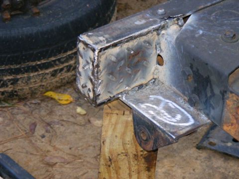 1978 Ford Bronco - A close-up view of a metal frame component, showing recent welding work and a portion of a tire.