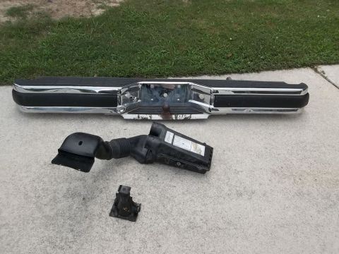 1995 Ford Bronco - Parts from a 1995 Ford Bronco, including the rear bumper and air intake system.