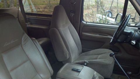 1995 Ford Bronco - Interior view showing the seats and dashboard of a vehicle, with 'Eddie Bauer' branding visible on the seat.