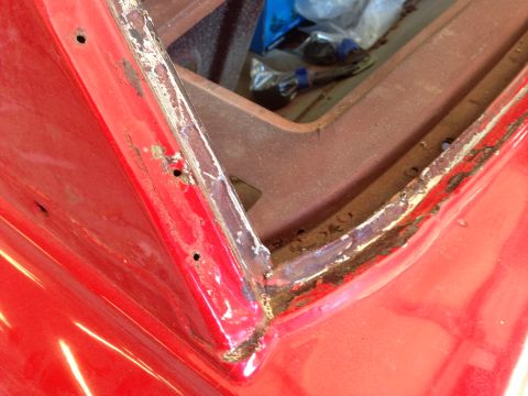 1964 Ford Fairlane - This image shows rust and damage on a car's body panel, indicating a need for repair.