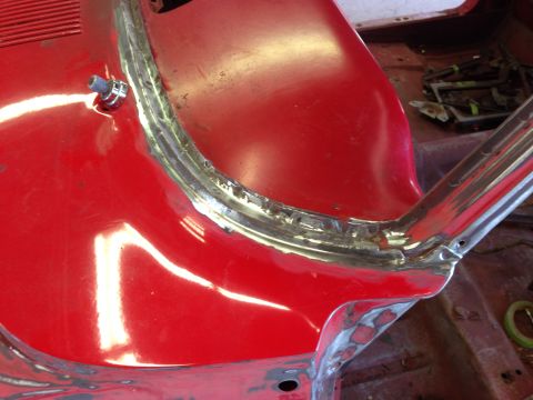 1964 Ford Fairlane - Close-up of a red car's interior, focusing on freshly welded seams around the windshield area during restoration.