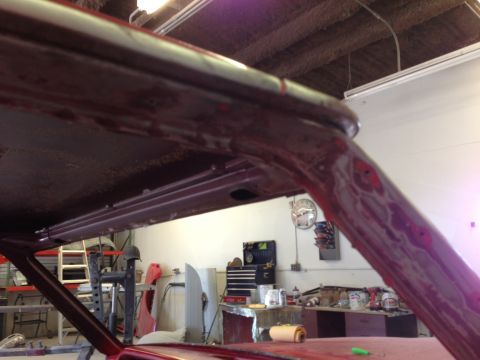 1964 Ford Fairlane - Car interior structure visible during restoration work, with primer applied to the A-pillar and roof.
