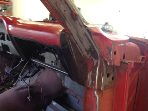 1964 Ford Fairlane - The interior of a car is shown with exposed metal and wiring, indicating ongoing restoration work.