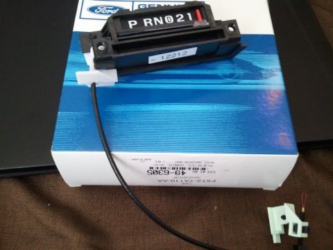 1994 Ford Bronco - A close-up of a Ford gear shift indicator part, displayed on its original packaging.