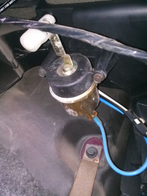 1992 Ford Bronco - Close-up of a vehicle's interior vacuum actuator component.