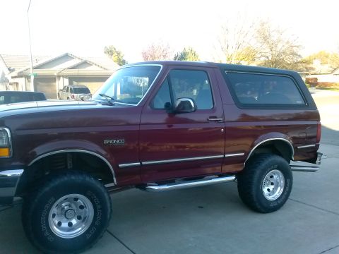 1992 Ford Bronco - This 1992 Ford Bronco is shown from the side with aftermarket wheels and side steps.