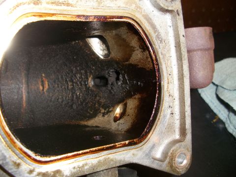 2001 Ford Crown Victoria - Engine intake manifold port shows significant carbon buildup and oil contamination.