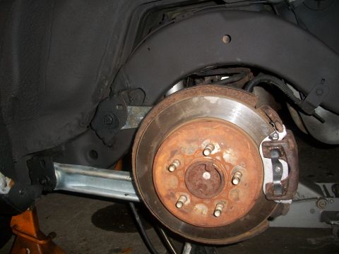 2001 Ford Crown Victoria - Close-up of the rear brake system on a 2001 Ford Crown Victoria, highlighting the rotor and caliper.