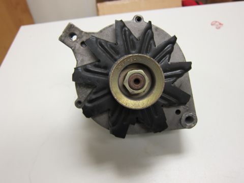 2001 Ford Crown Victoria - Close-up of an automotive alternator, showing its fan pulley and housing with visible part numbers.