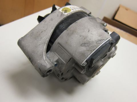 2001 Ford Crown Victoria - Close-up of an automotive alternator, likely a replacement part.
