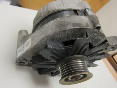 2001 Ford Crown Victoria - This is a close-up view of a car alternator, a crucial component for the vehicle's electrical system.