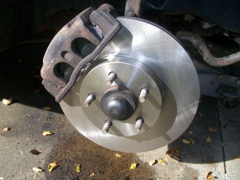 2001 Ford Crown Victoria - Brake rotor and caliper assembly shown in detail.