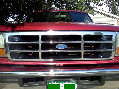 1995 Ford Bronco - Front view of a 1995 Ford Bronco's chrome grille and Ford emblem.