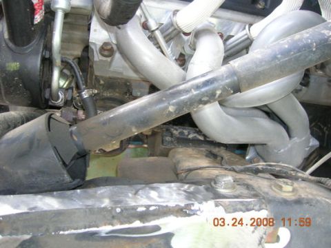 1995 Ford Bronco - Close-up view of engine components, including exhaust pipes and hoses, with a timestamp visible.