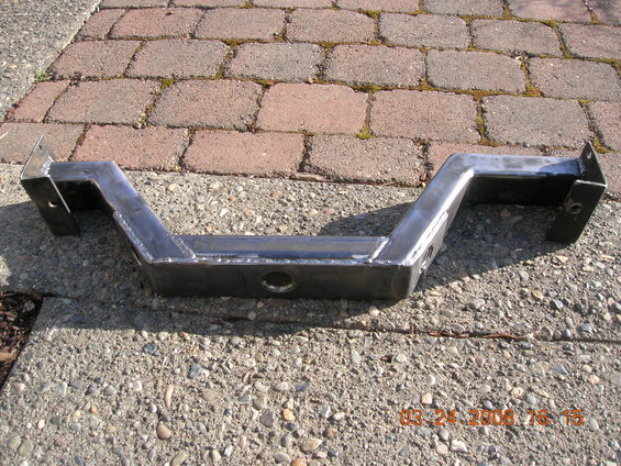 Custom metal crossmember with mounting brackets on concrete