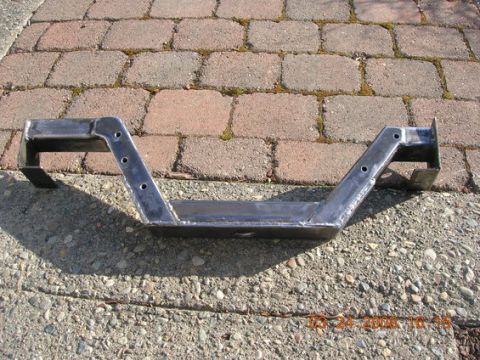 1995 Ford Bronco - Custom steel crossmember shown on a brick and gravel surface.