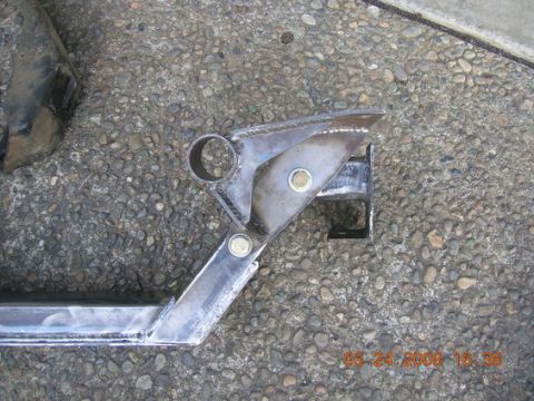 1995 Ford Bronco - Close-up of a custom-fabricated engine crossmember part, showing bolted connections and a circular mounting point.