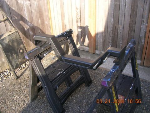 1995 Ford Bronco - Fabricated metal part resting on sawhorses in front of a wooden fence.