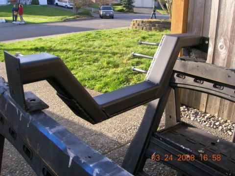 1995 Ford Bronco - A custom-fabricated engine crossmember part is shown mounted on a stand outdoors.