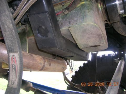 1995 Ford Bronco - Close-up view of the undercarriage, focusing on the engine crossmember and exhaust system.