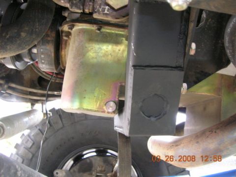 1995 Ford Bronco - Underside view of an engine oil pan and a fabricated crossmember, likely for off-road modification.