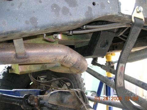 1995 Ford Bronco - Close-up view of the undercarriage, focusing on the exhaust system and suspension components.