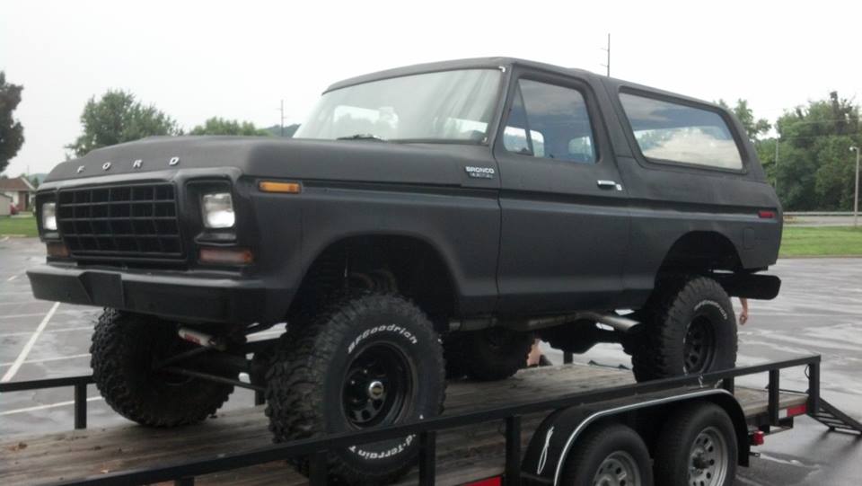 Black lifted 1979 Ford Bronco 3/4 front view on trailer