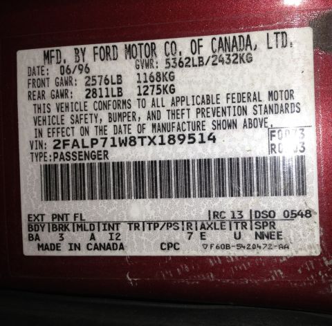 2004 Ford Crown Victoria - Vehicle identification label shows manufacturing date of June 1996 and VIN.