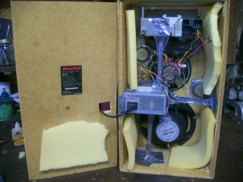 Open electronic device with speakers, power supply, and foam padding