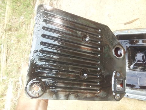 1988 Ford Bronco - A dirty transmission pan and filter, likely from a vehicle needing maintenance.