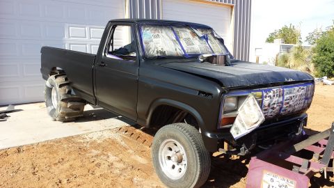 1995 Ford Bronco - This modified pickup truck has oversized rear tires and a hood scoop, suggesting it's built for off-road or drag racing.
