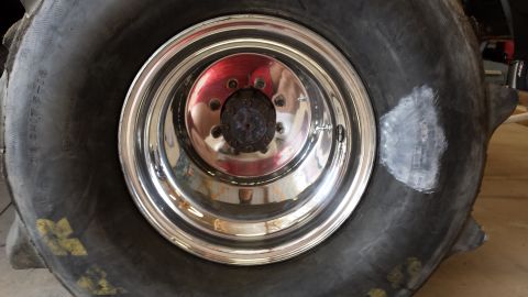 1995 Ford Bronco - A close-up view of a patched tire and a chrome rim.