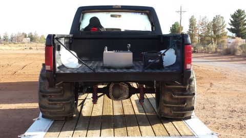 1995 Ford Bronco - This modified Ford Bronco, likely from the early to mid-1990s, is equipped for off-road racing with specialized tires and a fuel cell.