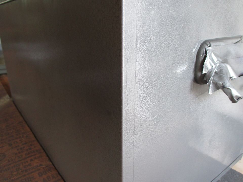 Close-up of a painted tool chest corner and handle