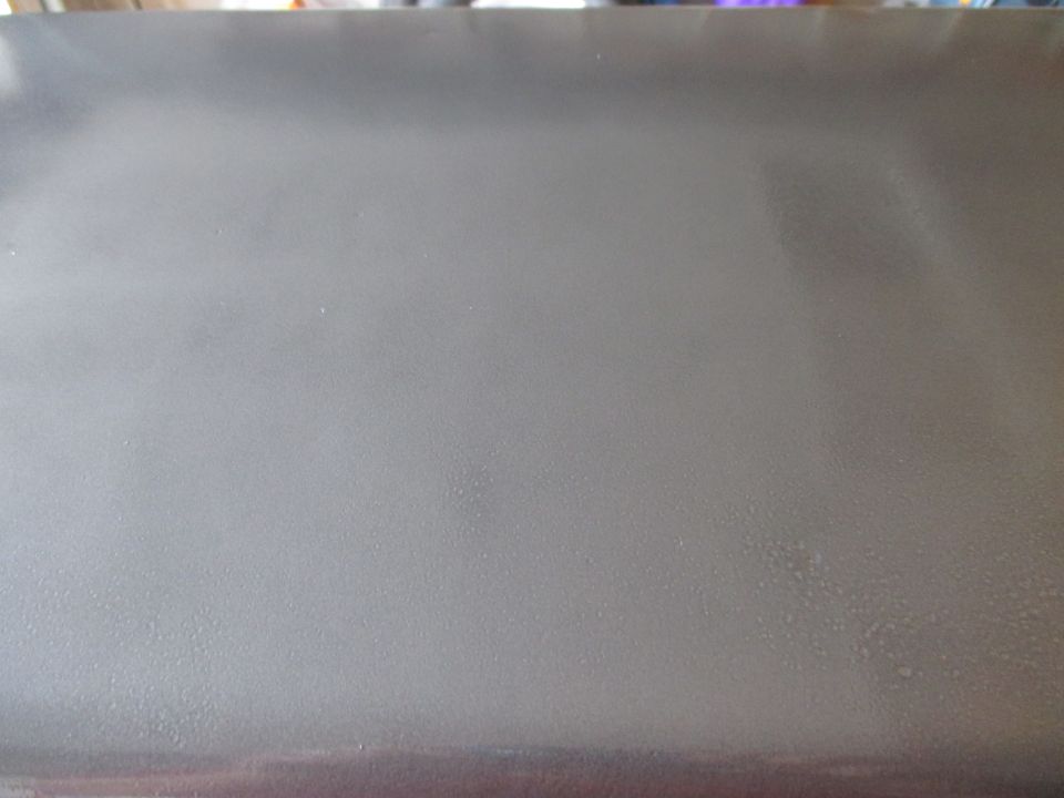 Close-up of a painted gray tool chest lid surface