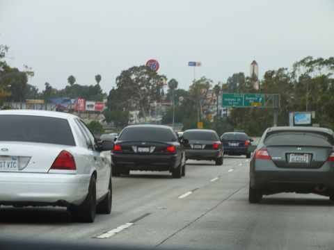 2003 Ford Crown Victoria - Photo of cars on a freeway with a 76 gas station sign in the background, not a technical document.